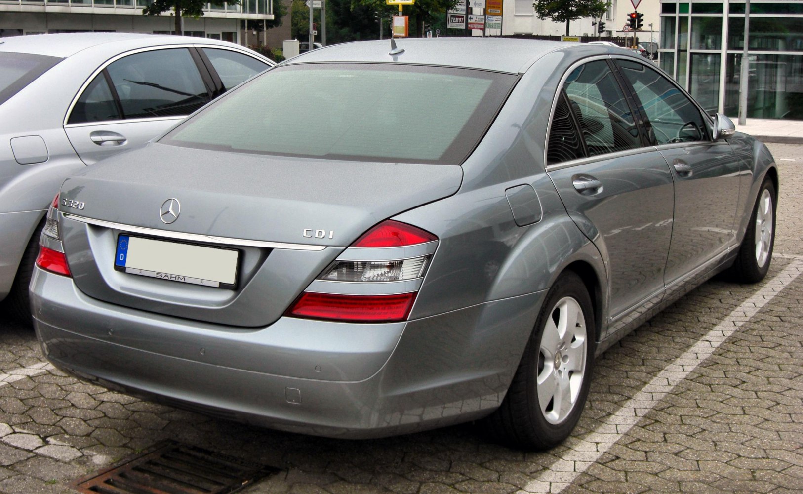 Rear of luxury sedan with distinctive taillights and badges