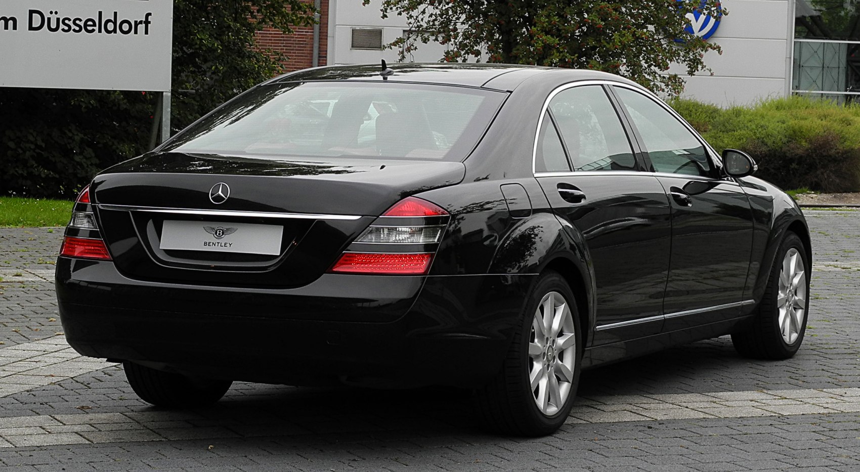 Rear view with sleek taillights and chrome trim on extended rear panels