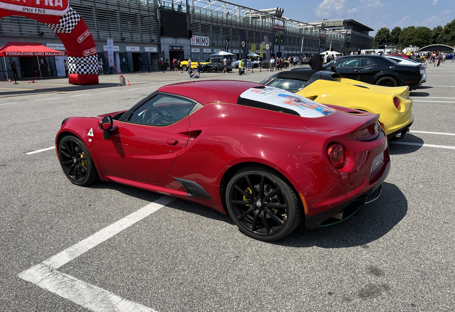 Mid-engine sports coupe with black wheels and aerodynamic rear side profile