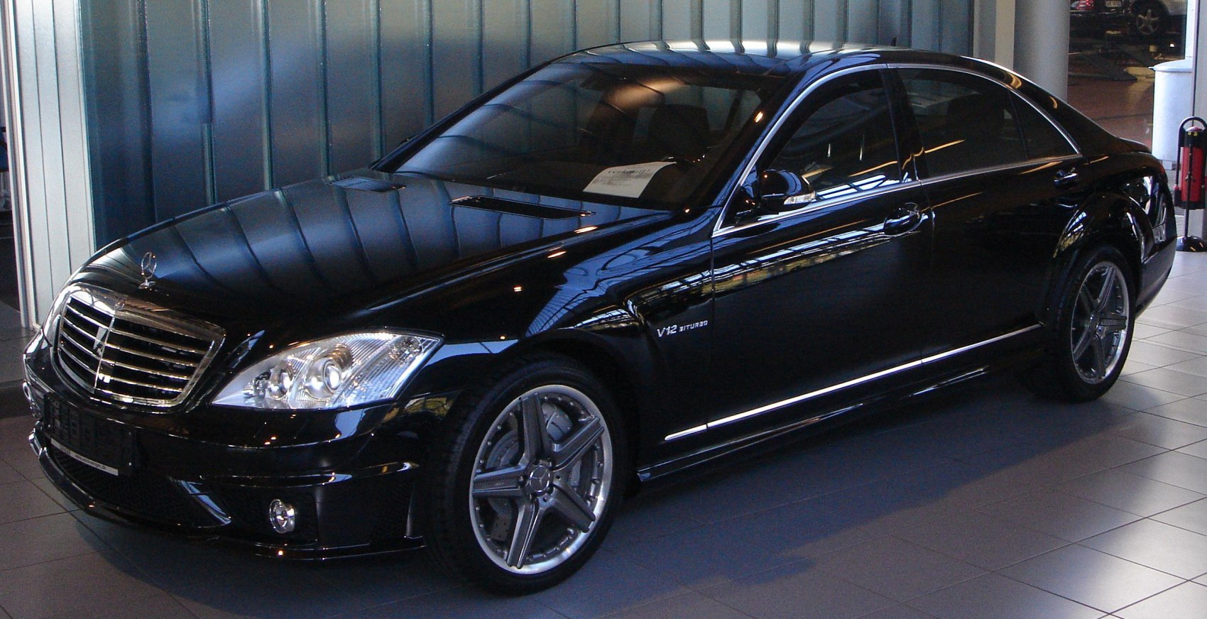 Black luxury sedan with V12 Biturbo engine and AMG alloy wheels.