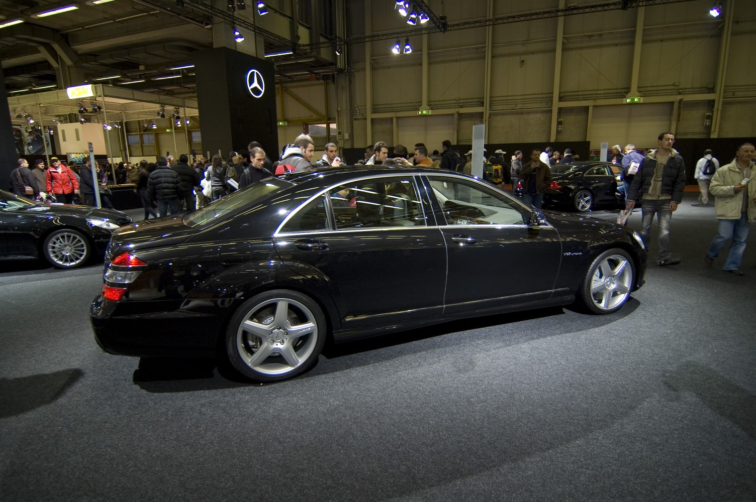 Luxury sedan side view with AMG wheels and chrome trim