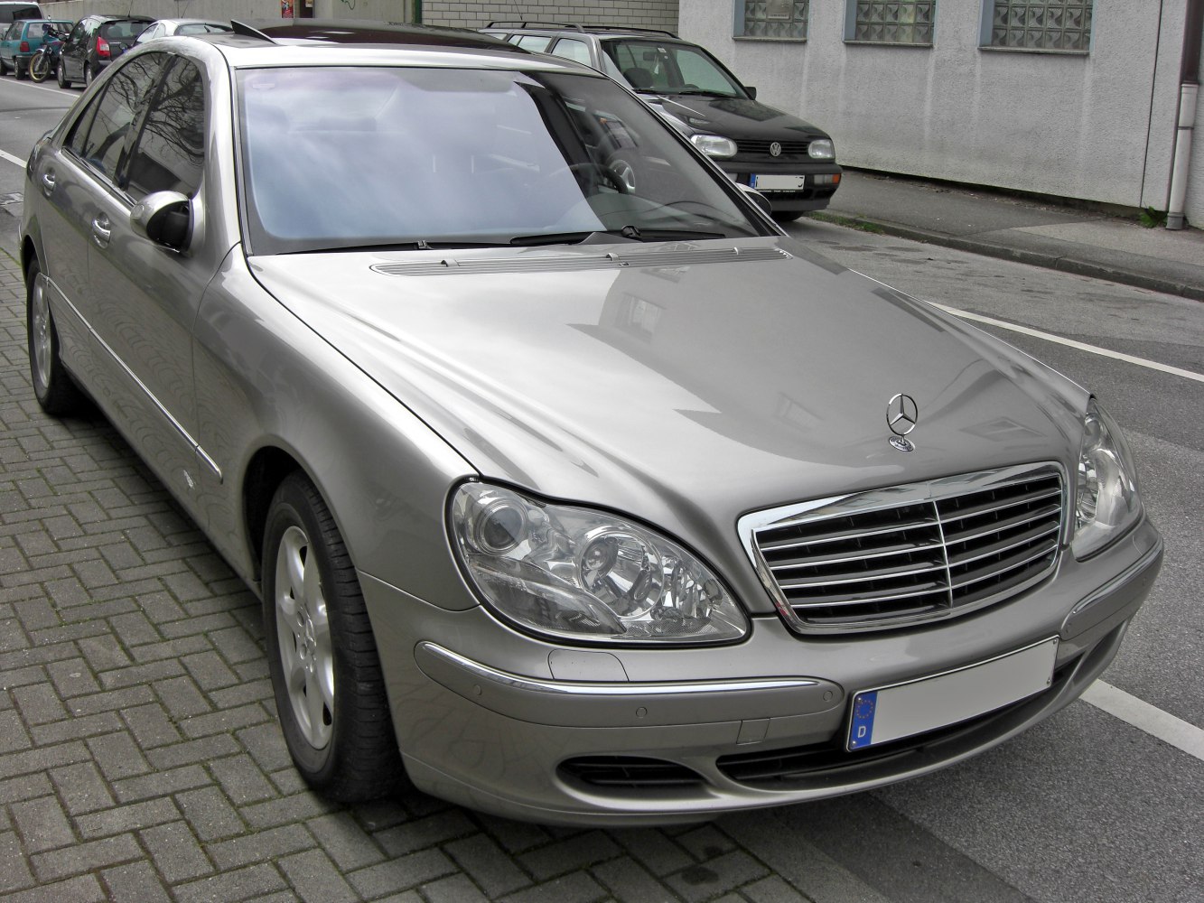 Luxury sedan front with chrome grille and dual headlights