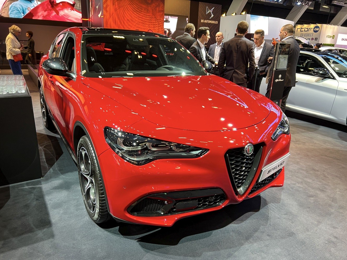 Red SUV front with distinctive grille and sleek LED headlights