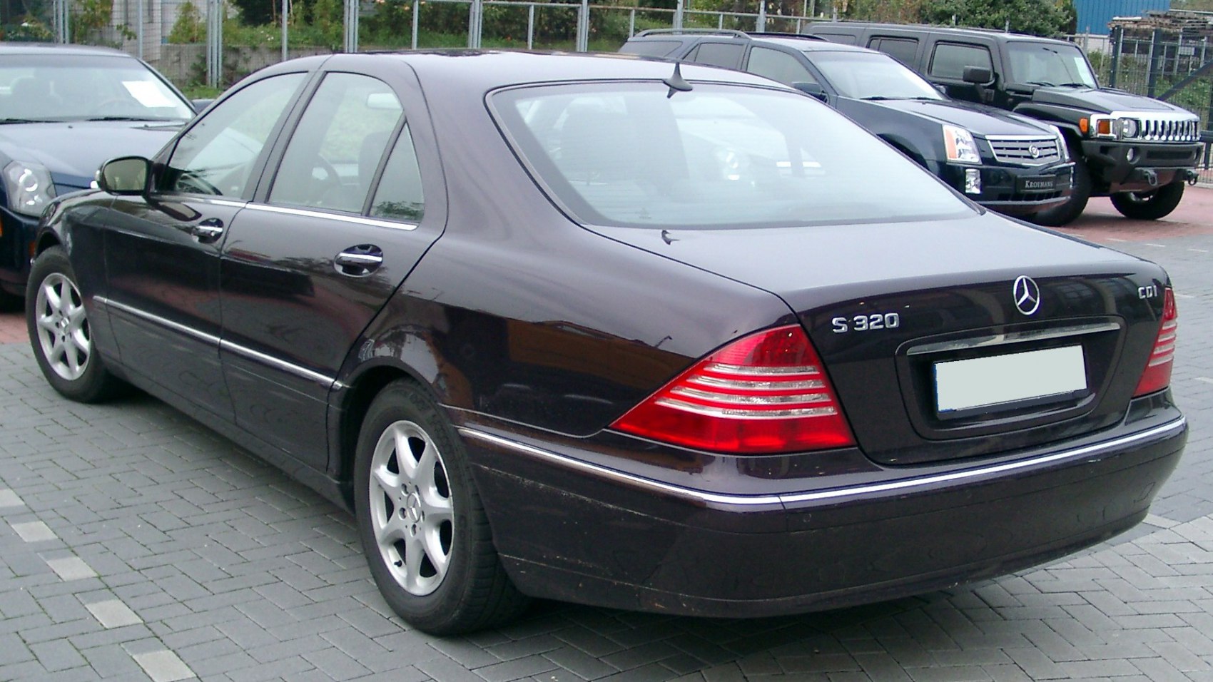 Rear side view of sleek luxury sedan with distinct taillights and alloy wheels