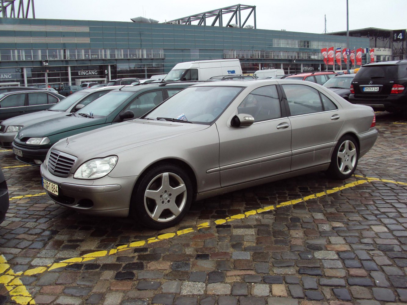 Silver luxury sedan with alloy wheels side profile