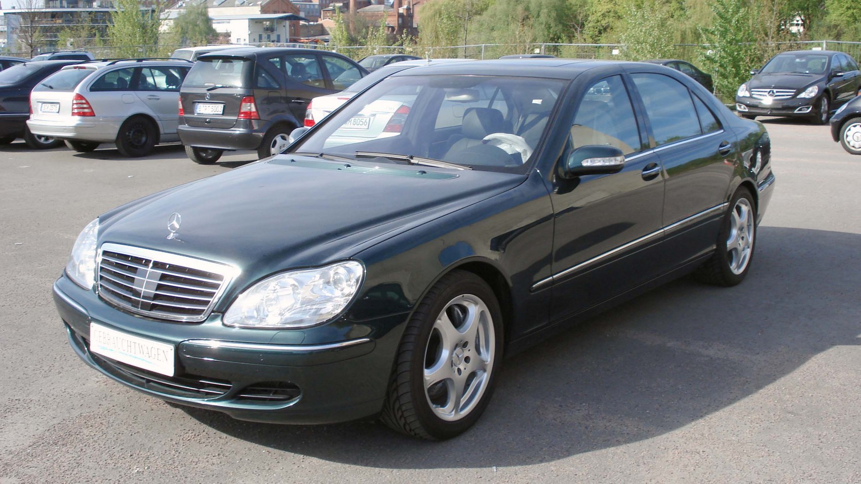 Luxury sedan with chrome grille and alloy wheels in black.