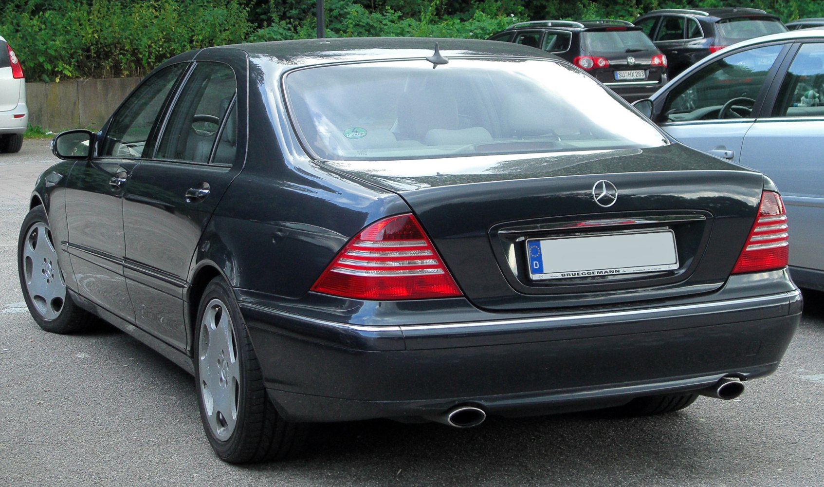 Rear view of a luxury sedan with dual exhausts and distinctive taillights