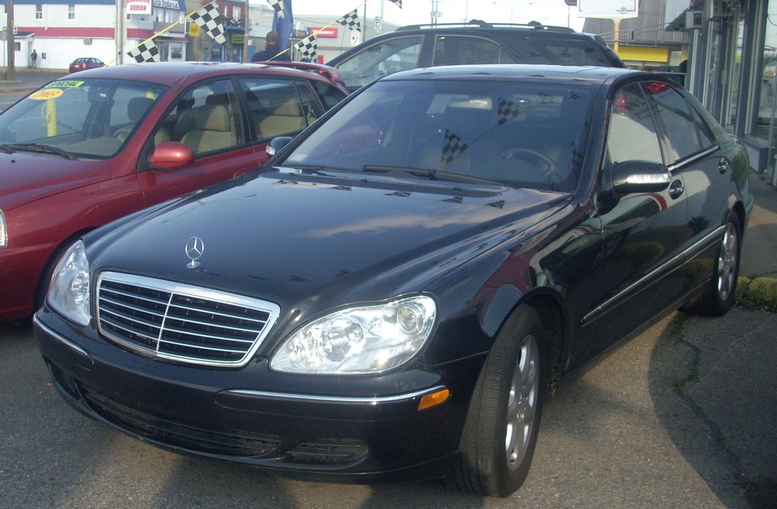 Luxury black sedan with chrome grille and iconic dual headlights