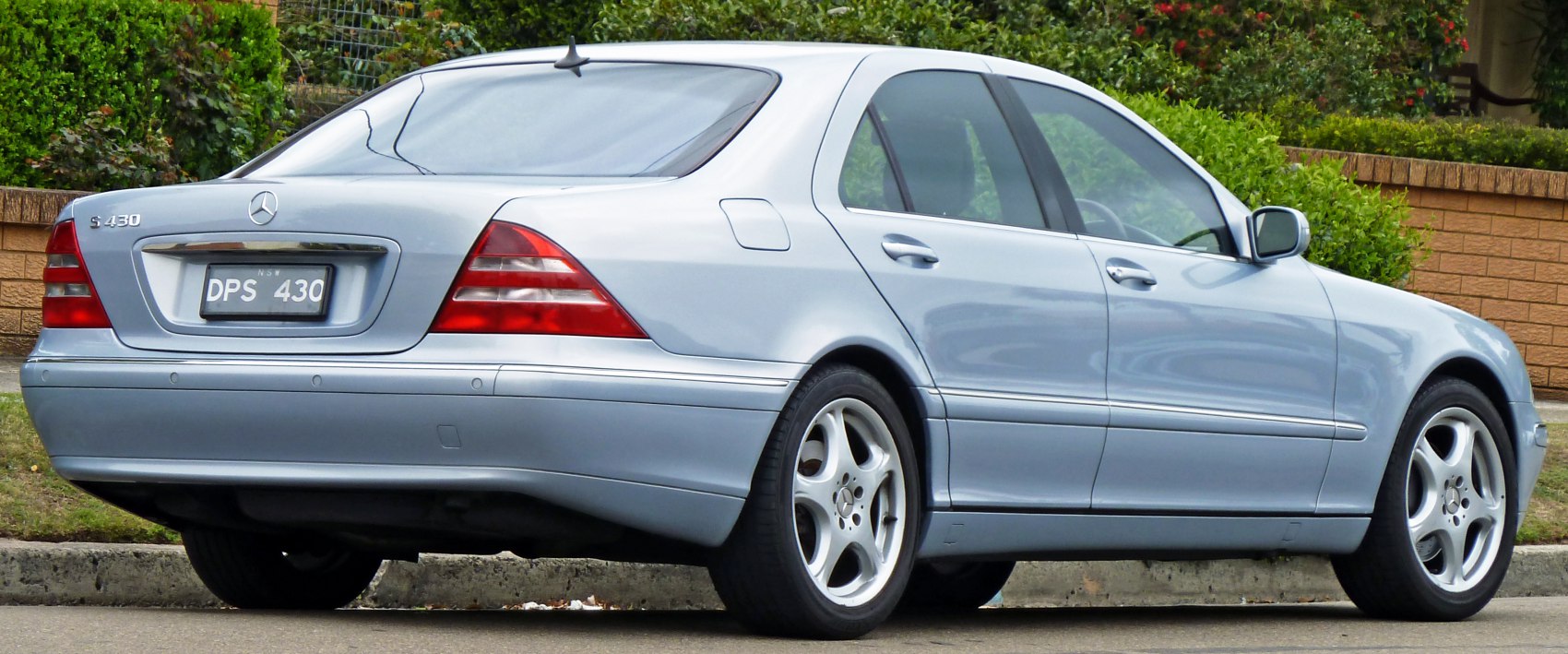 Rear and side profile of a classic luxury sedan