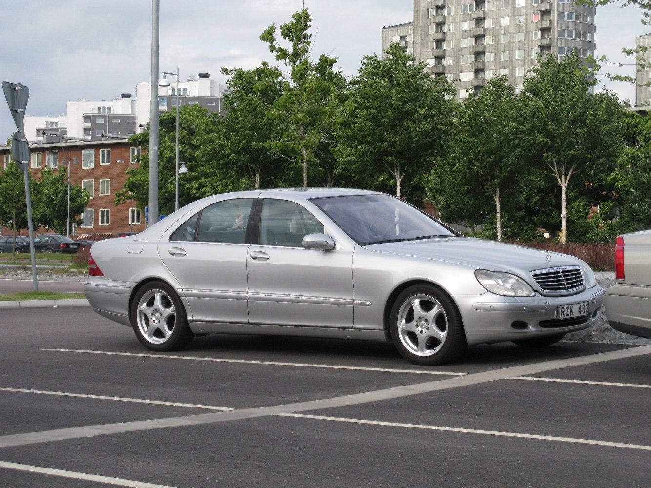 Silver luxury sedan with rounded front and five-spoke wheels
