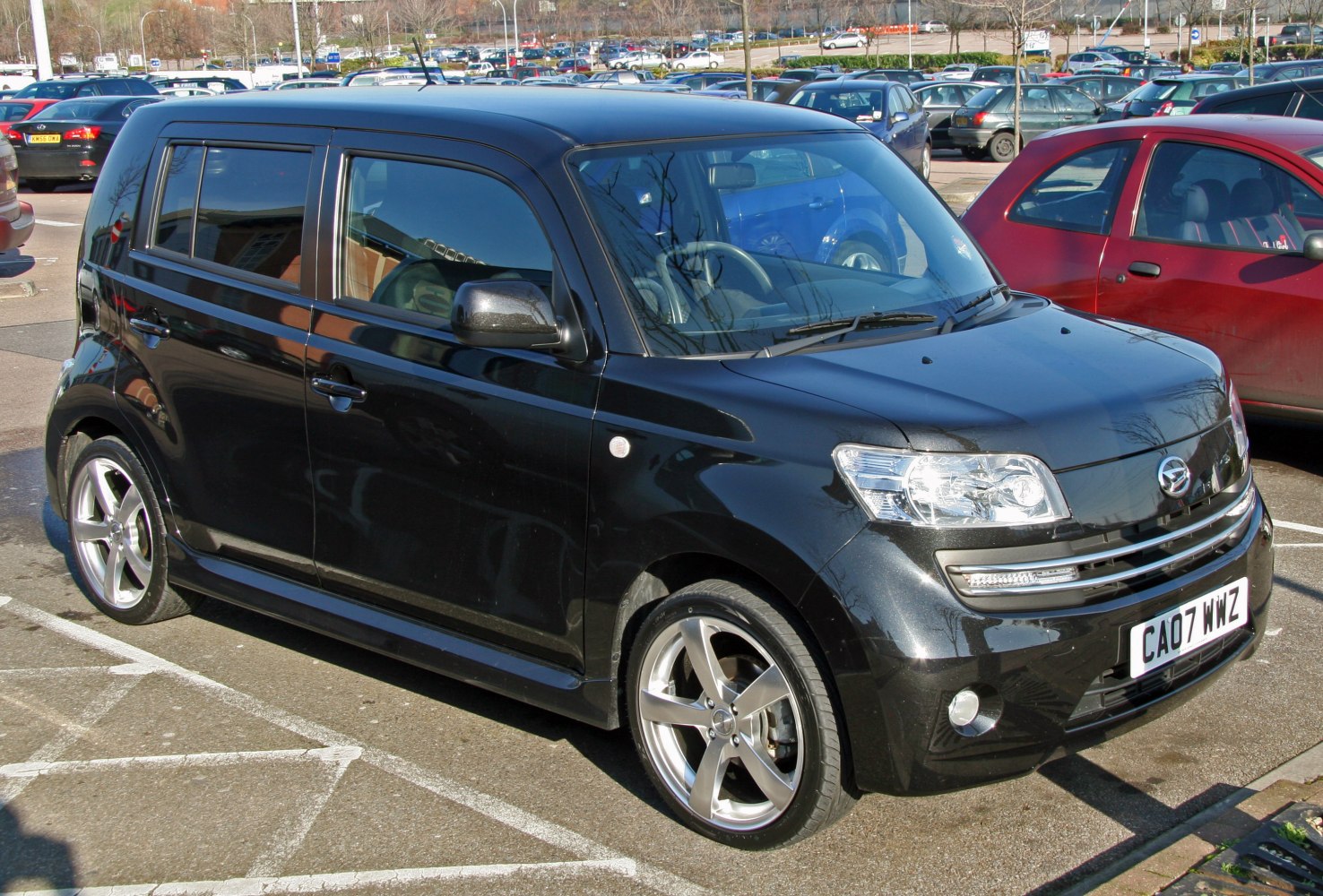 Black compact hatchback with angular front and alloy wheels