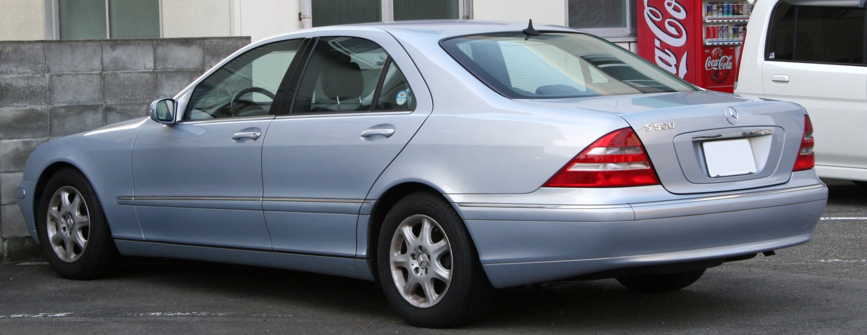 Rear-side view of silver luxury sedan with distinct taillights and trim