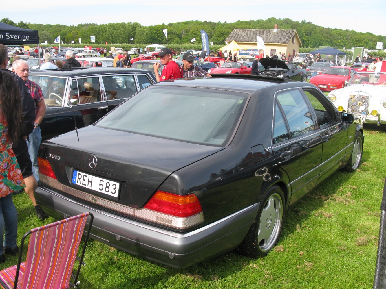 Rear view of sedan with V12 badge and classic taillights