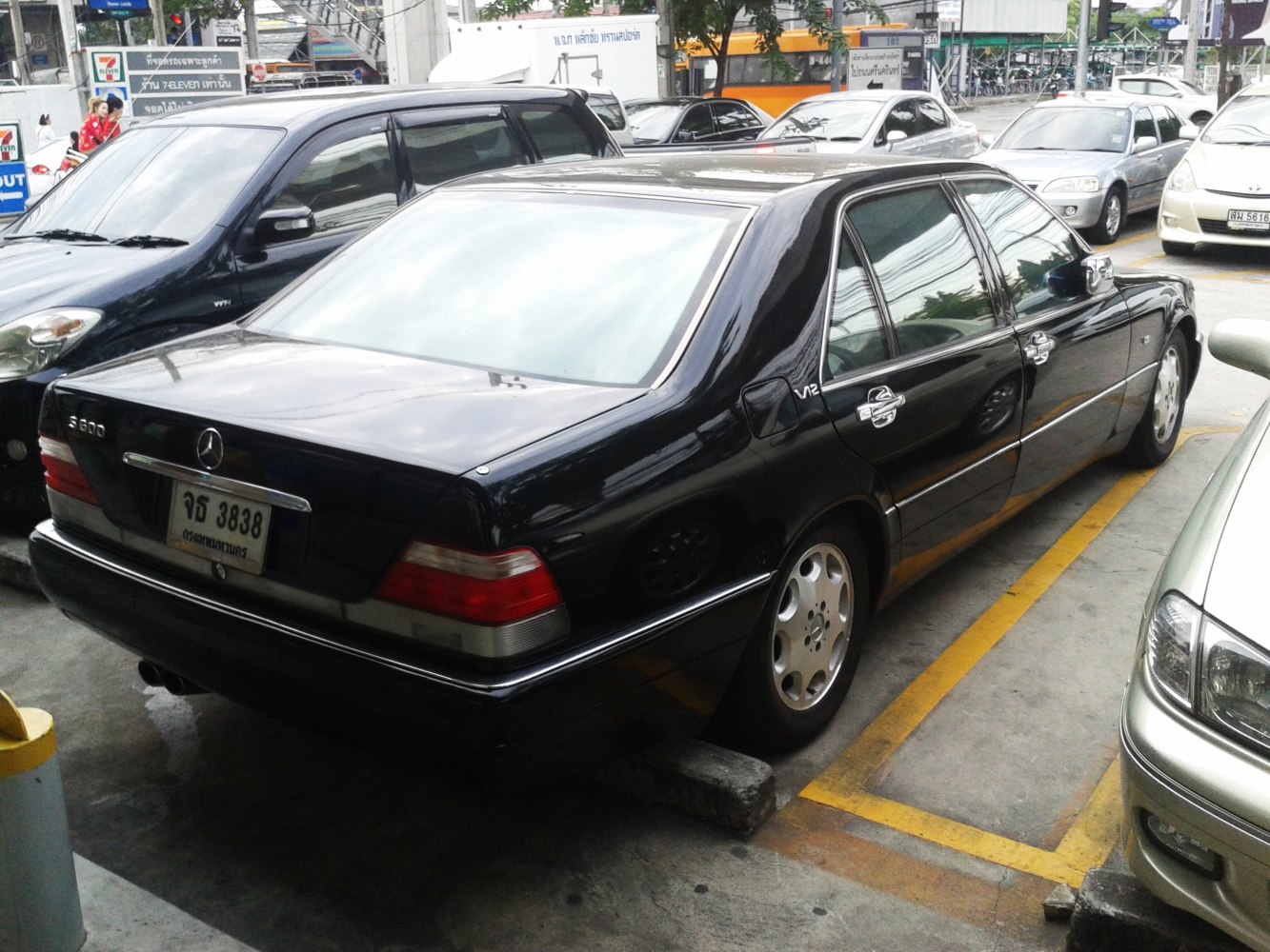 Luxury sedan rear view with V12 badge and facelift taillights