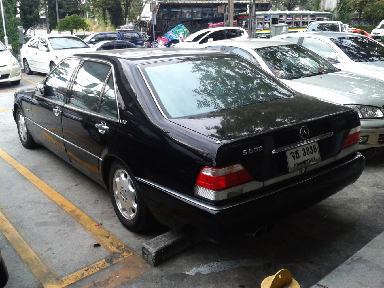 Rear side view with tail lights and extended sedan body