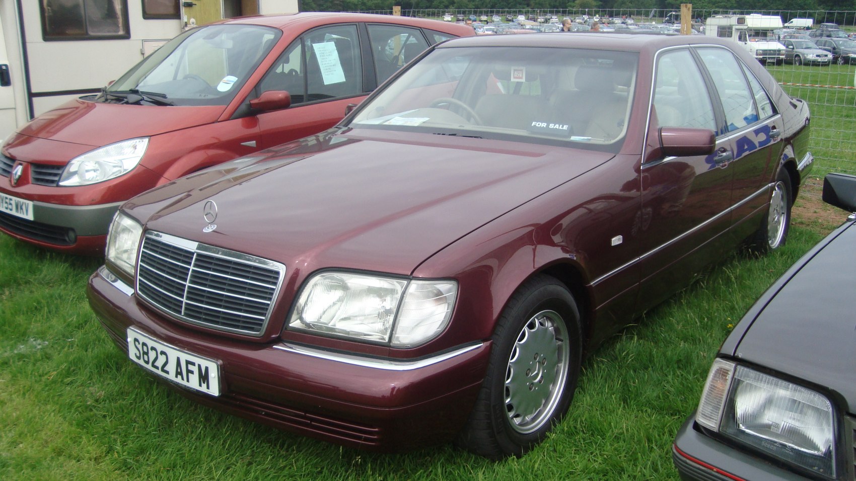 Front view of a classic luxury sedan with chrome grille and rectangular headlights
