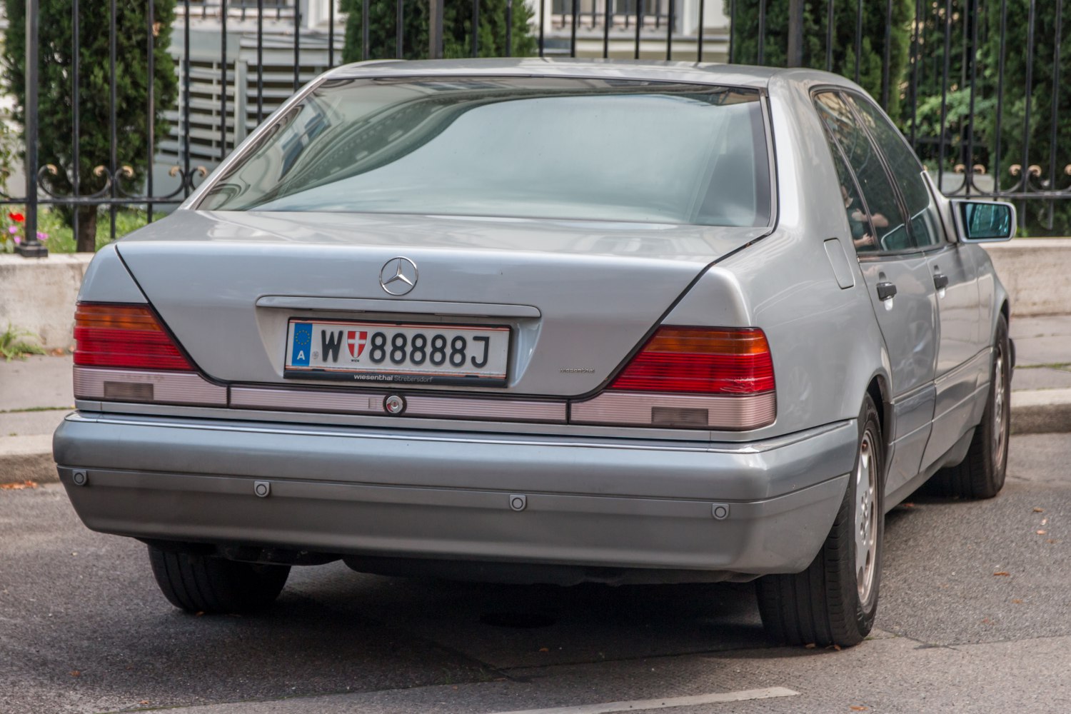 Rear view with distinctive taillights and silver sedan body.
