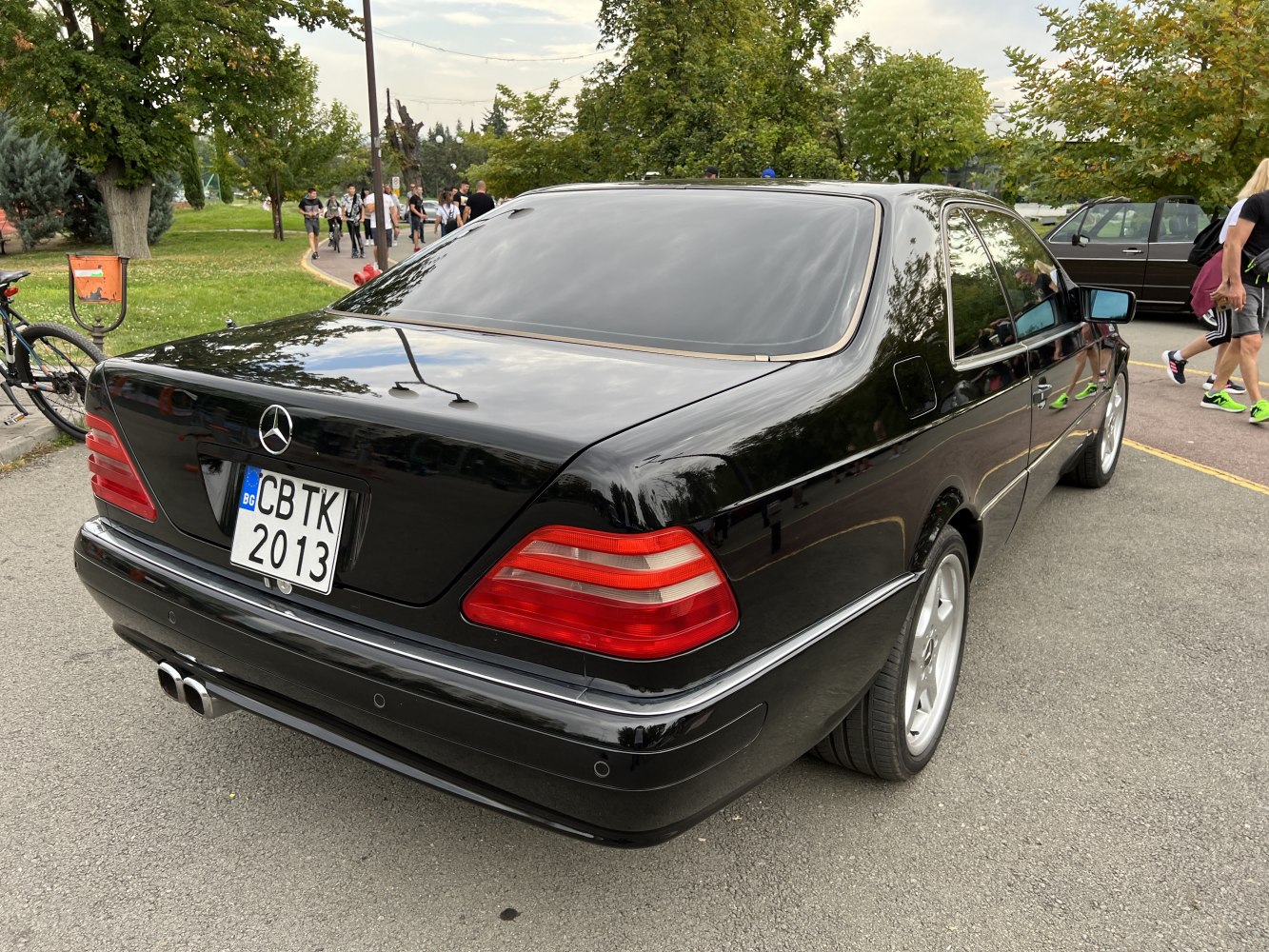 Black luxury coupe rear with tinted windows and dual exhaust