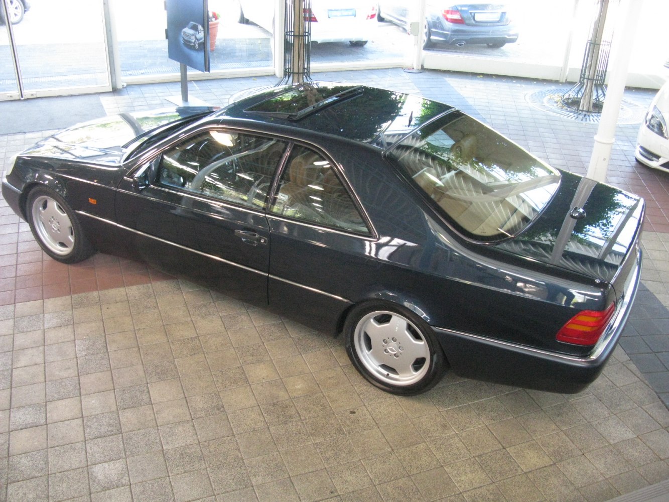Sleek coupe side profile with classic alloy wheels