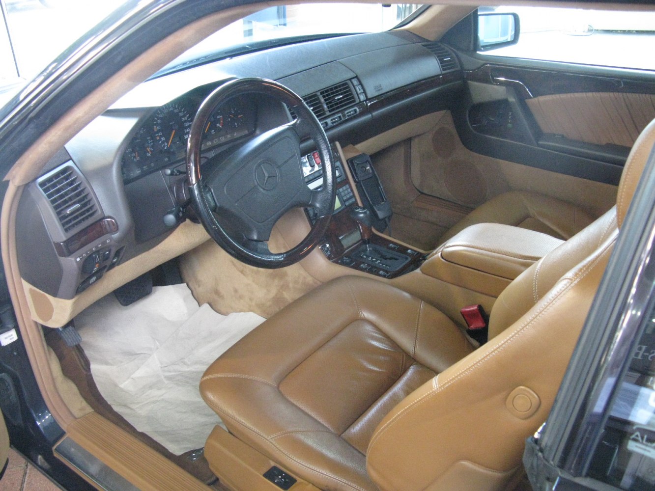 Leather seats and wood trim dashboard in vintage coupe interior