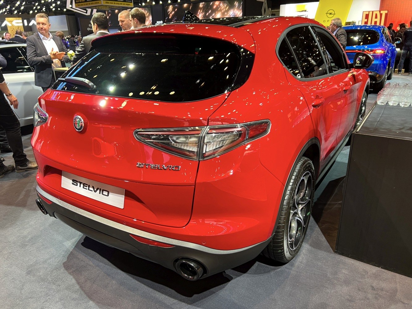 Rear and side view of red SUV with distinctive taillights and alloy wheels