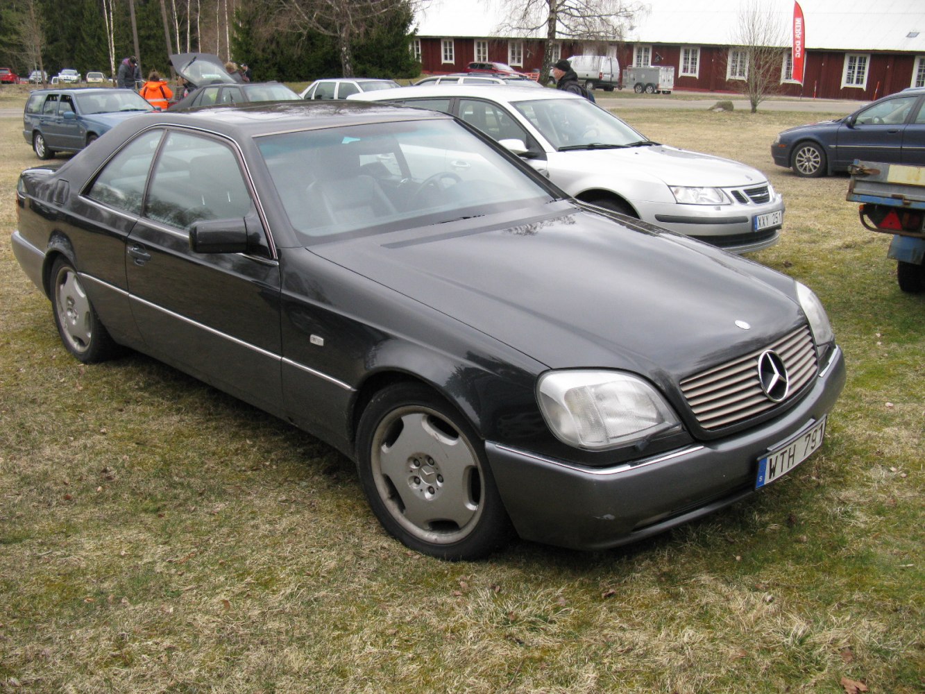 Front-side view of a sleek 1990s luxury 2-door coupe with grille and alloy wheels