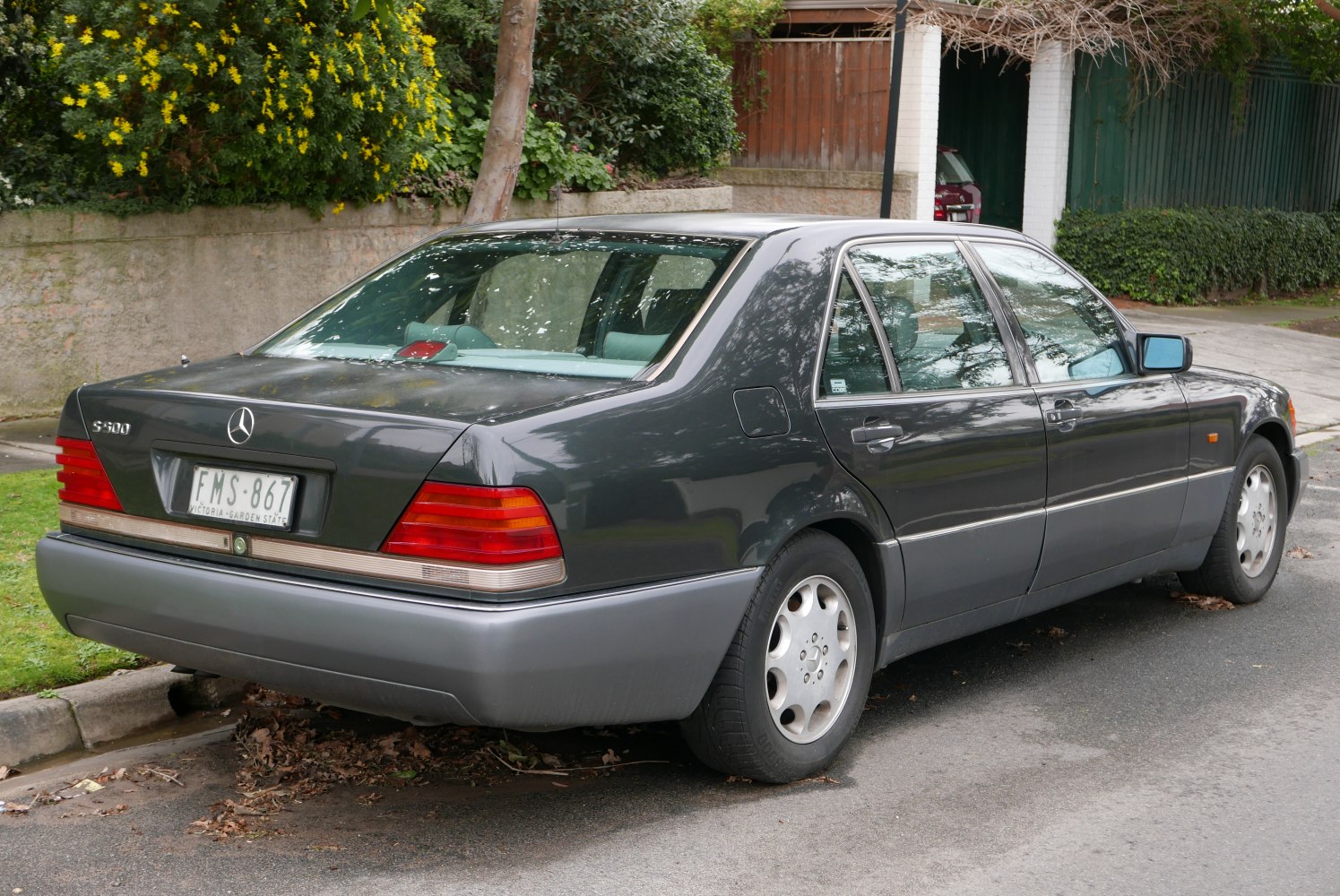 Rear-side view of a classic long-wheelbase luxury sedan with distinct taillights and alloy wheels