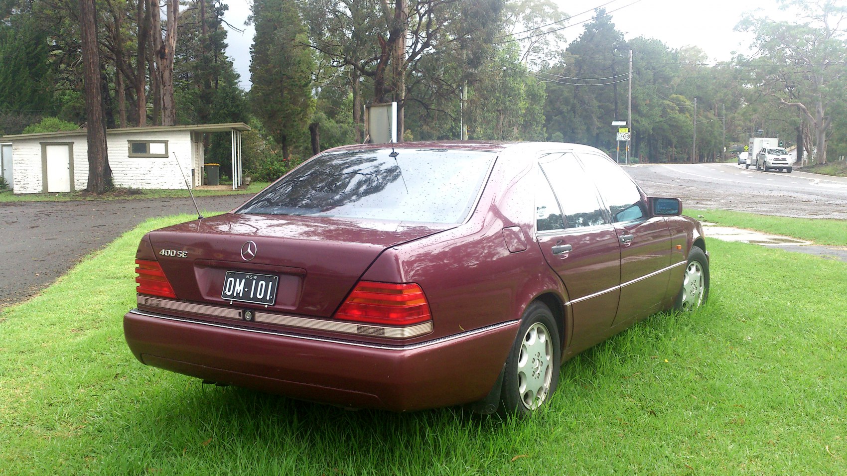 Rear view with distinctive tail lights and badge of a 90s luxury sedan
