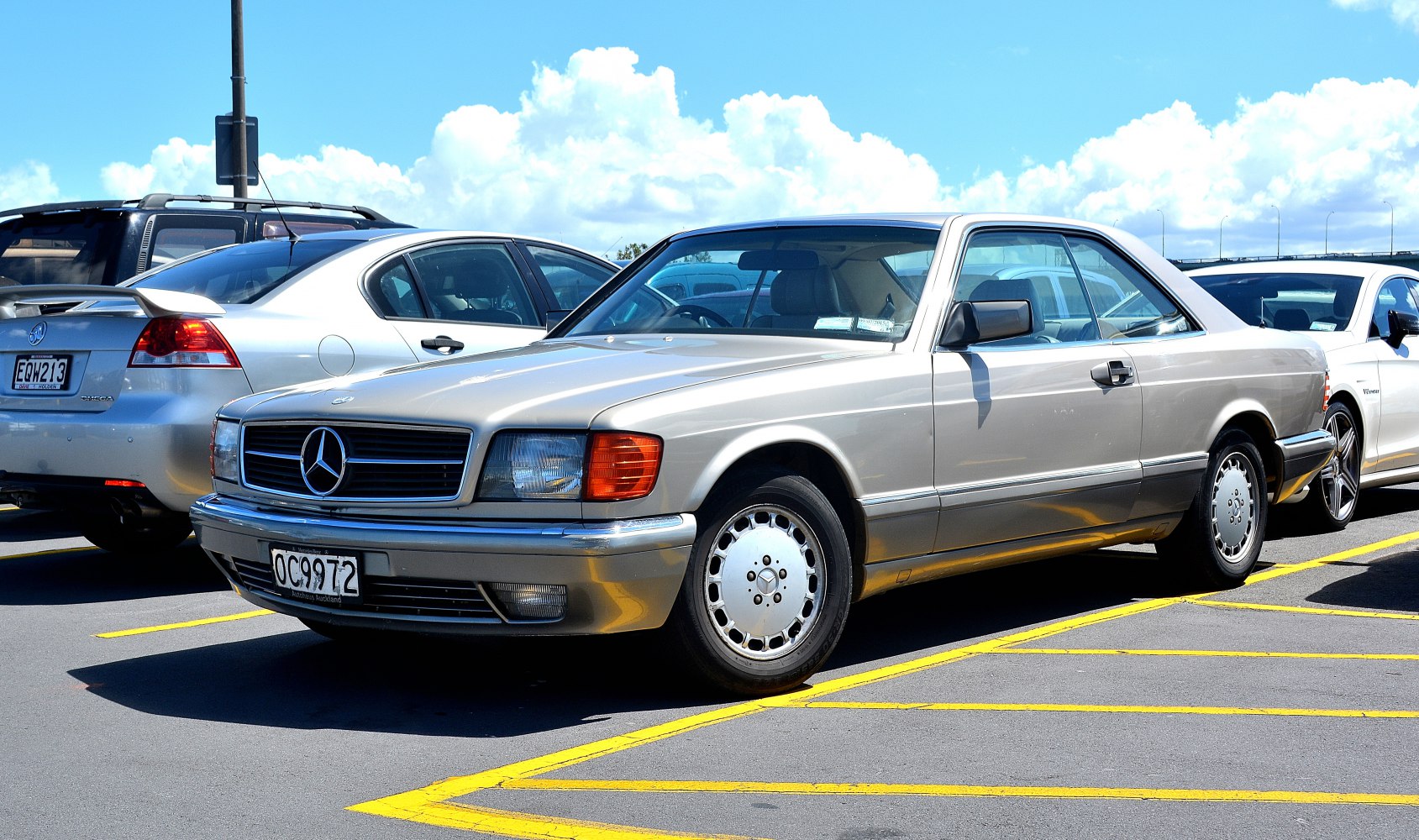 Silver two-door Mercedes coupe with classic 1980s design and alloy wheels