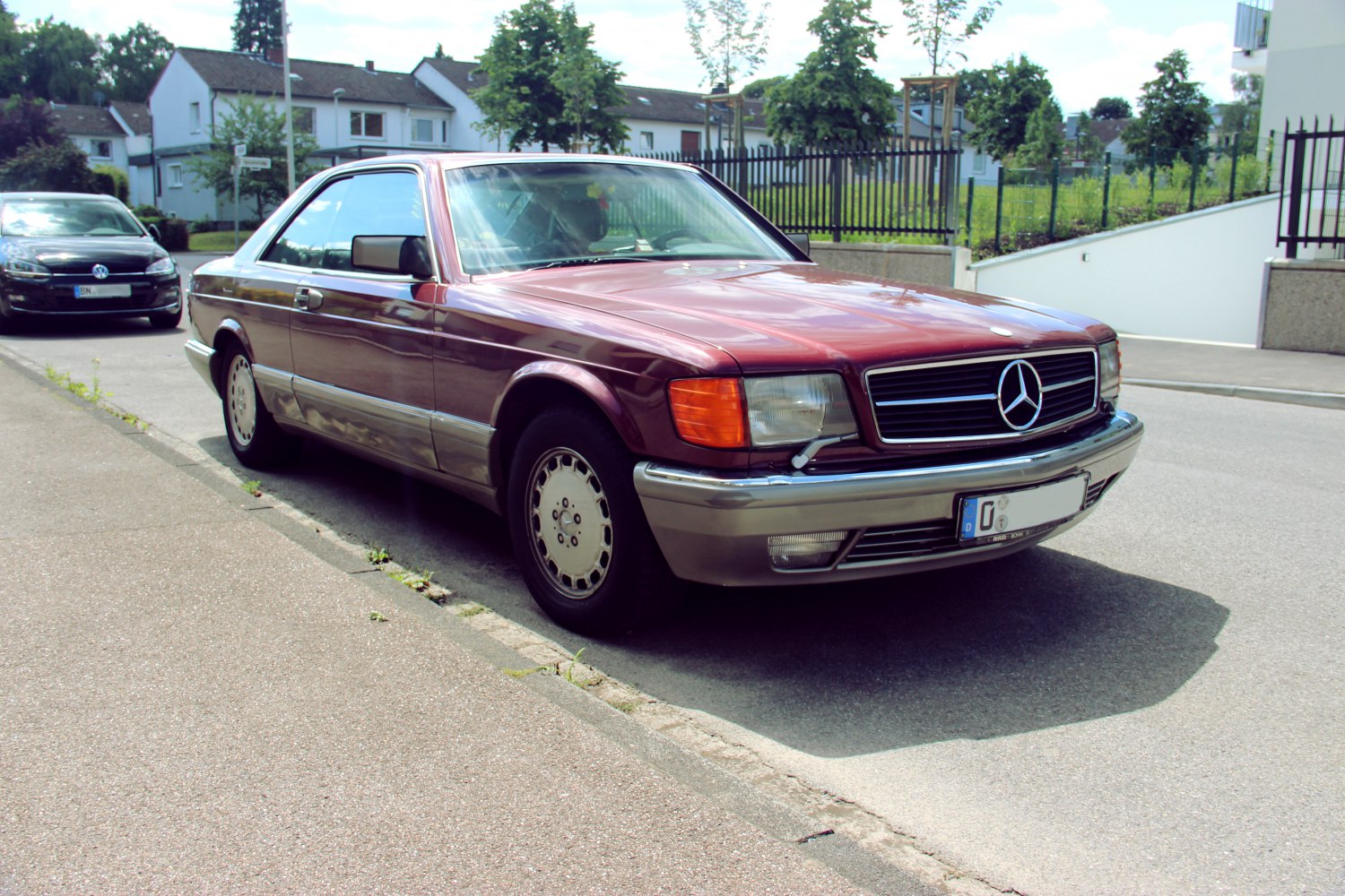 Front-side view of classic coupe with vintage wheels and chrome bumper