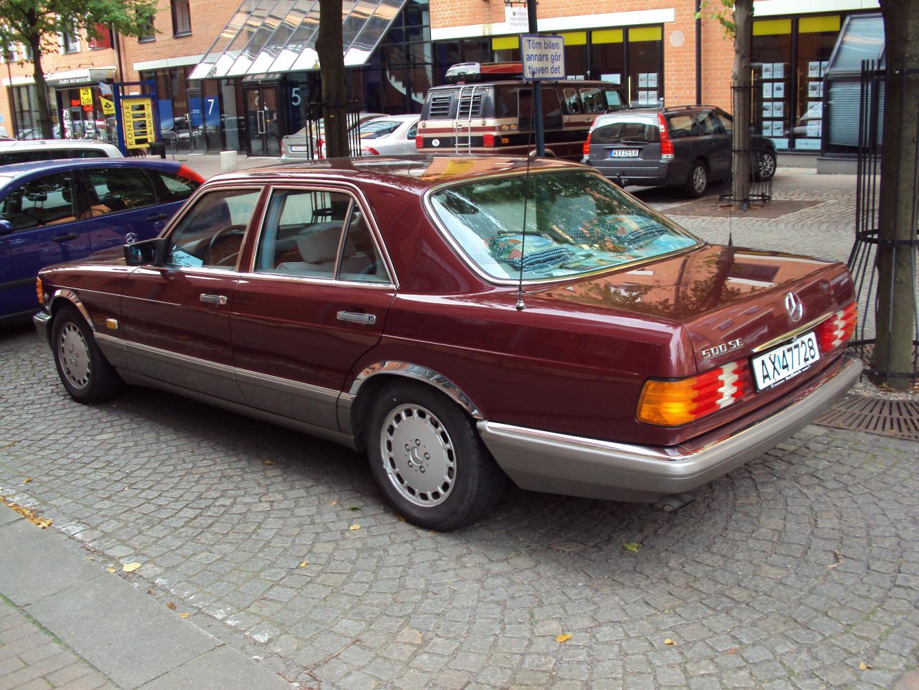 Luxury sedan rear and side with chrome trim and vintage design