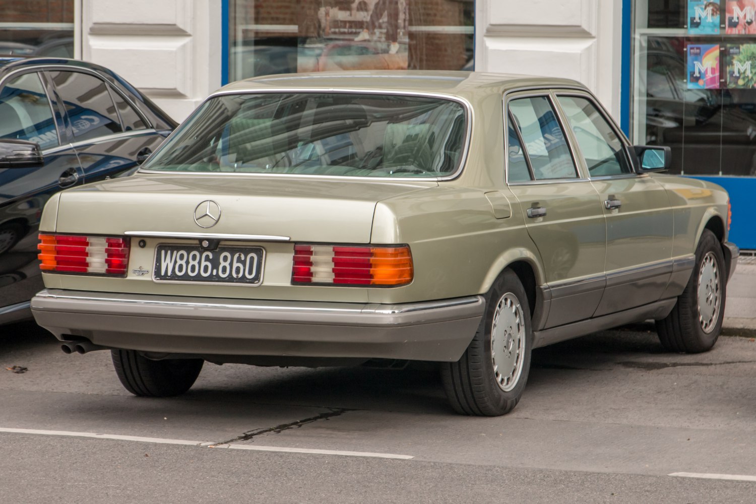 Rear view of vintage luxury sedan with distinctive tail lights and design.