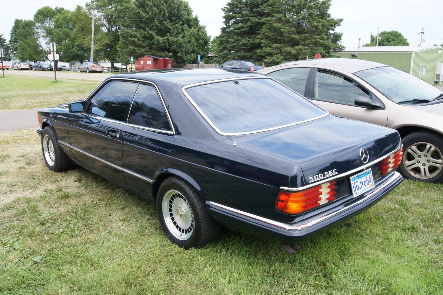 Vintage rectangular tail lights and classic alloy wheels on a two-door coupe.