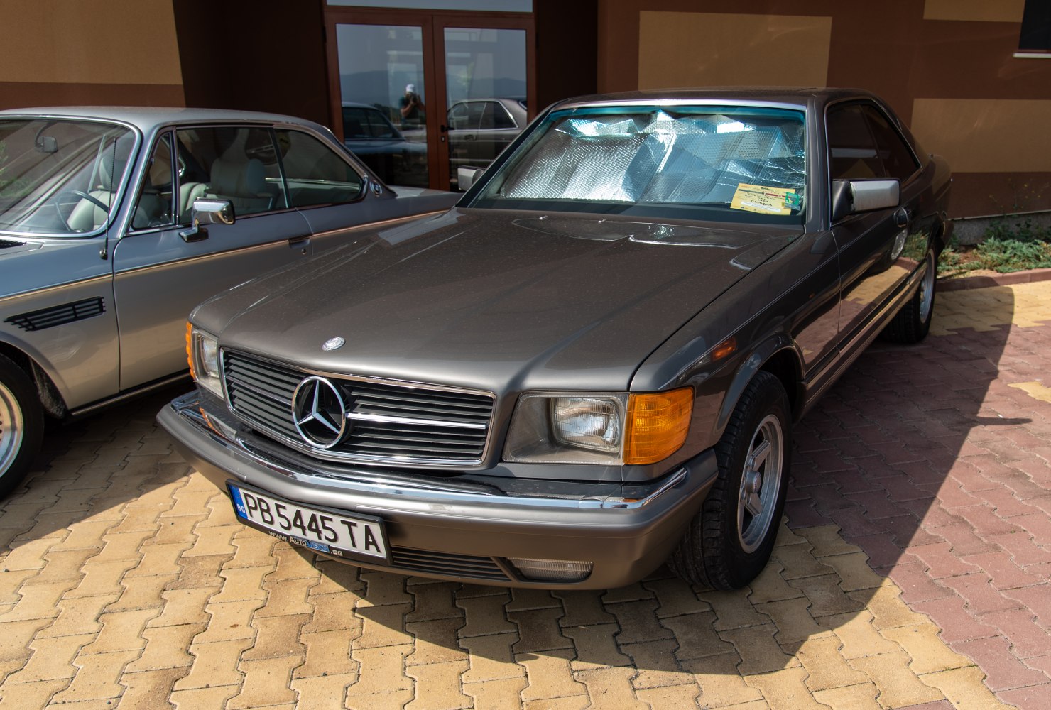 Classic luxury coupe front with vintage grille and square headlights