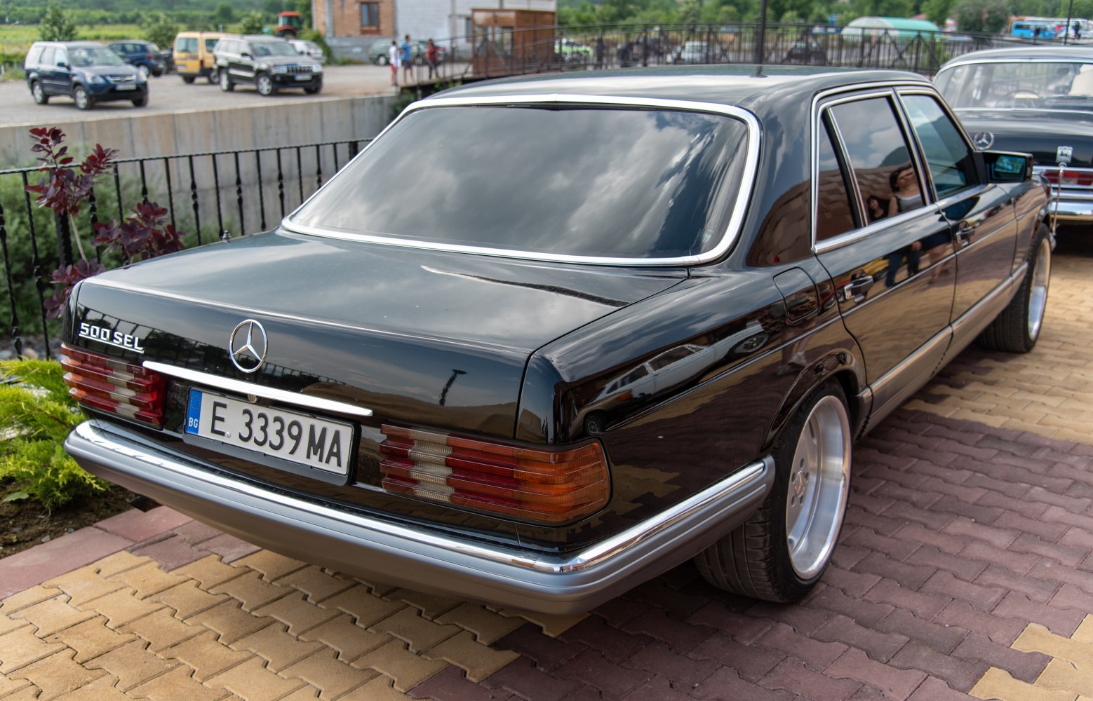 Tinted windows, chrome trim, rear light clusters of vintage luxury sedan