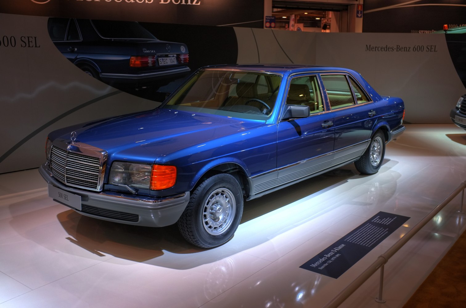Luxury sedan with long wheelbase and chrome grille in blue.