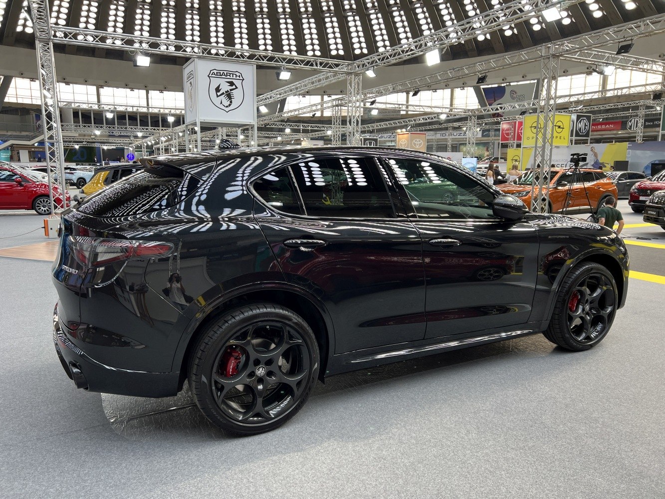 Black crossover SUV rear side with sporty wheels and red brake calipers
