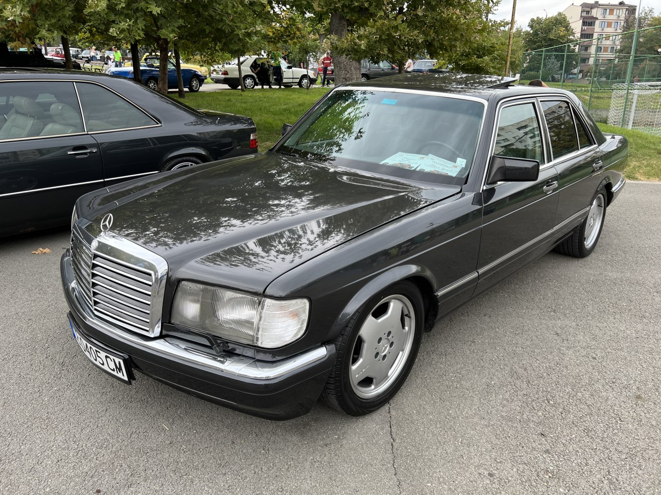 Classic luxury sedan front side with chrome grille and emblem