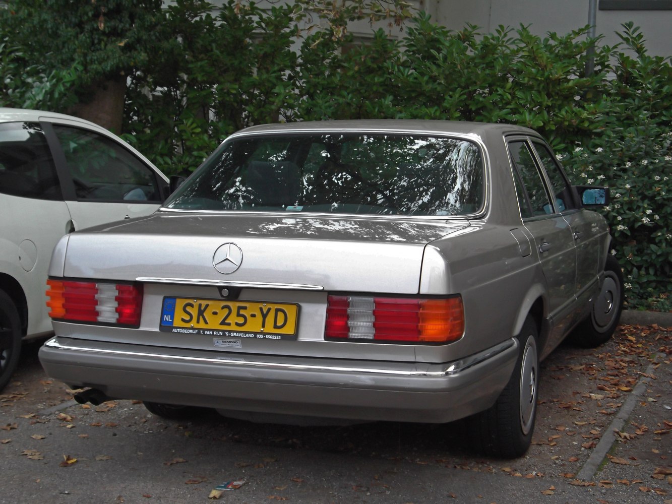 Rear view of a classic sedan with distinctive taillights and chrome trim.