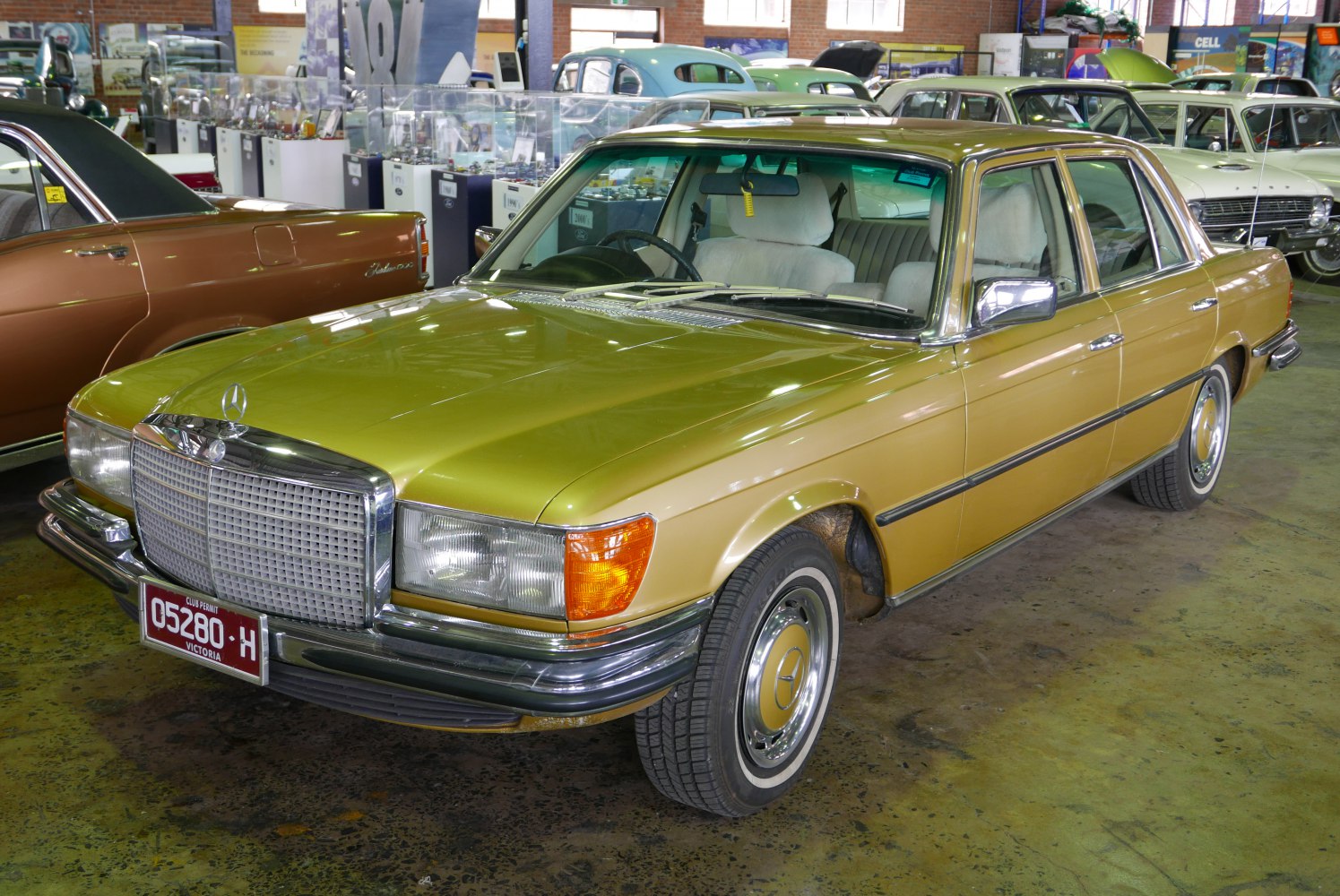 Wide chrome grille and round headlights on vintage luxury sedan
