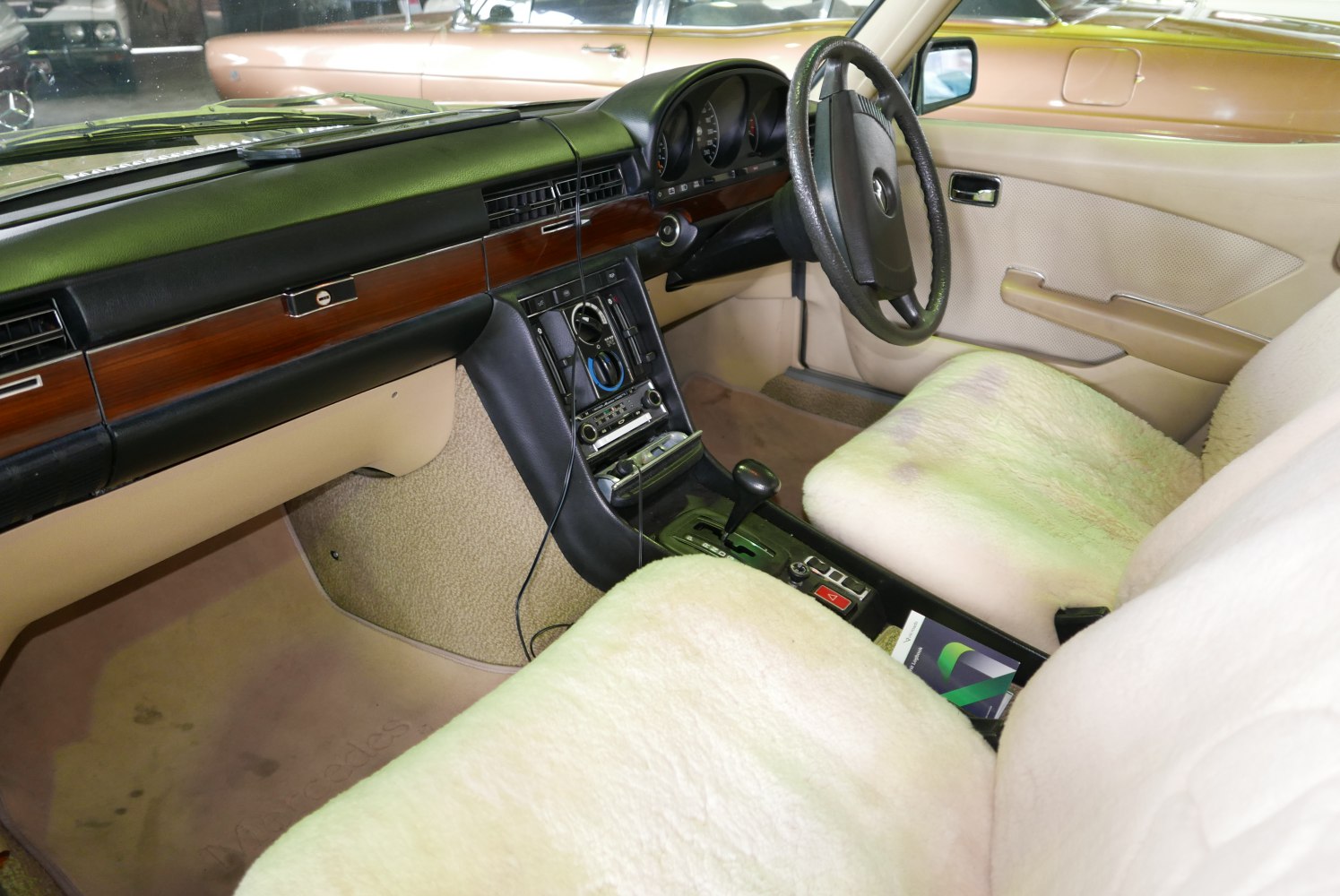 Wood dashboard, sheepskin seat covers, automatic transmission, and analog controls.