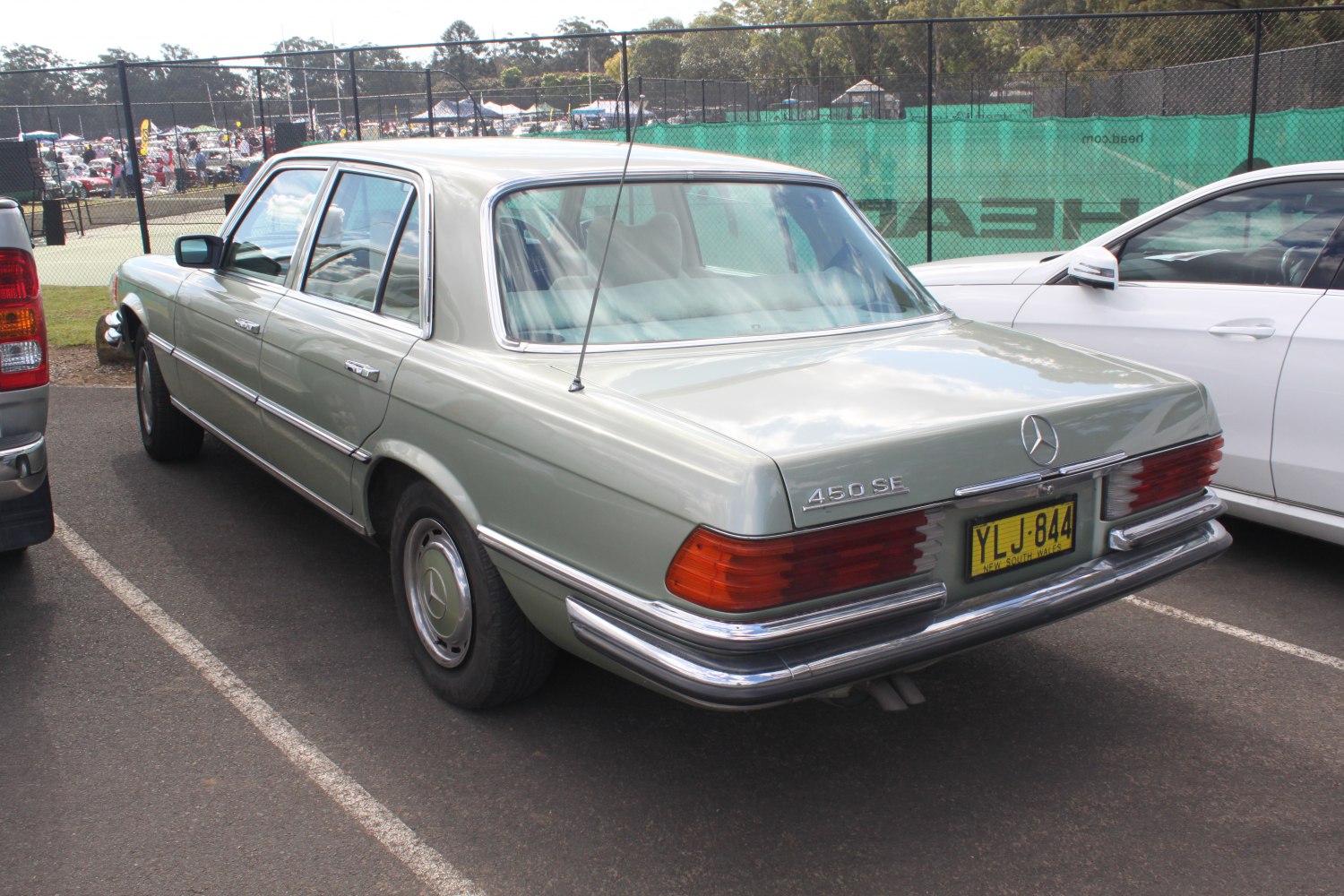 Classic 1970s luxury sedan rear side with chrome details and distinctive taillights