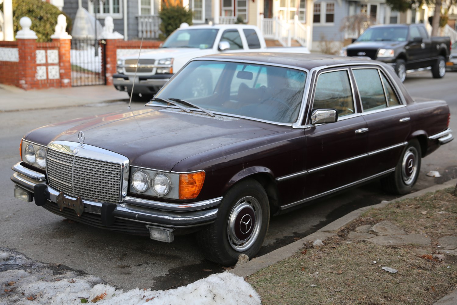 Vintage luxury sedan with chrome grille and dual round headlights