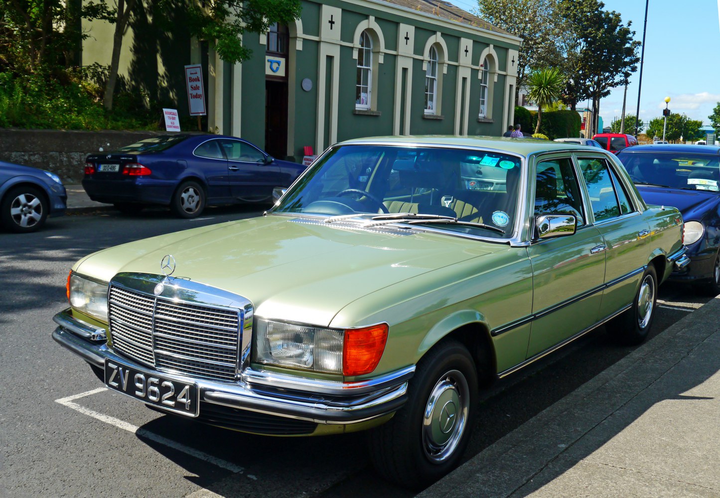 Wide chrome grille and rounded rectangular headlights on vintage sedan