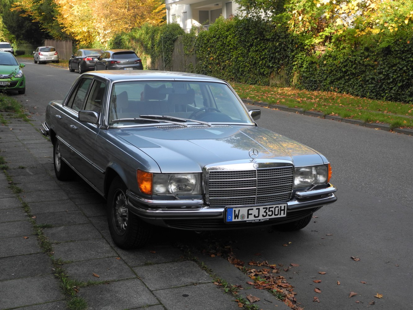 Front view of classic vintage luxury sedan with chrome grille and headlights.