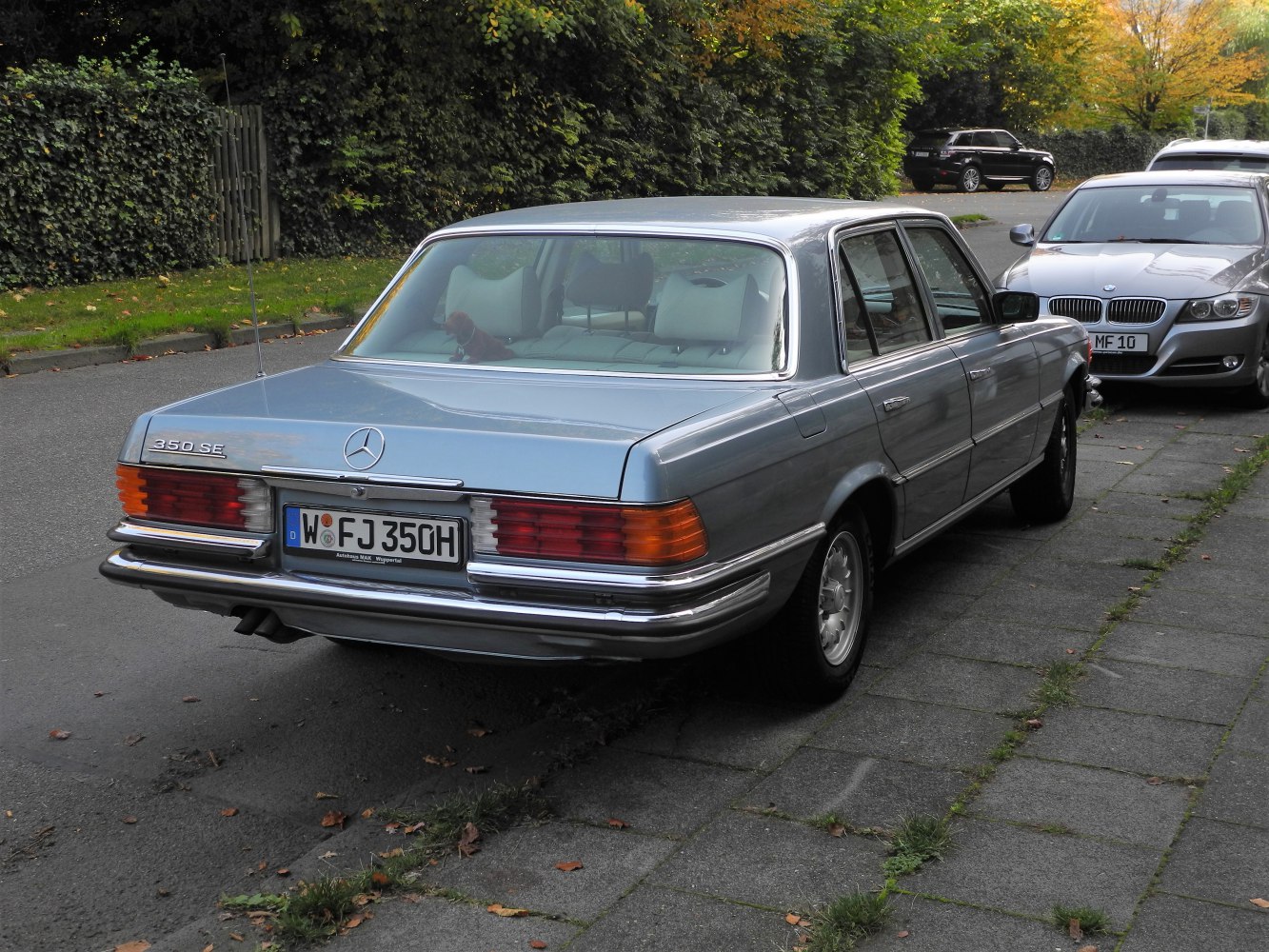 Rear view of a vintage sedan with classic rectangular taillights and chrome bumpers