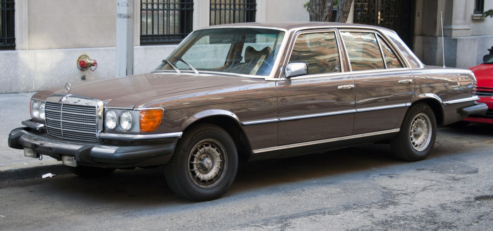Vintage 1970s sedan with chrome grille and round headlights