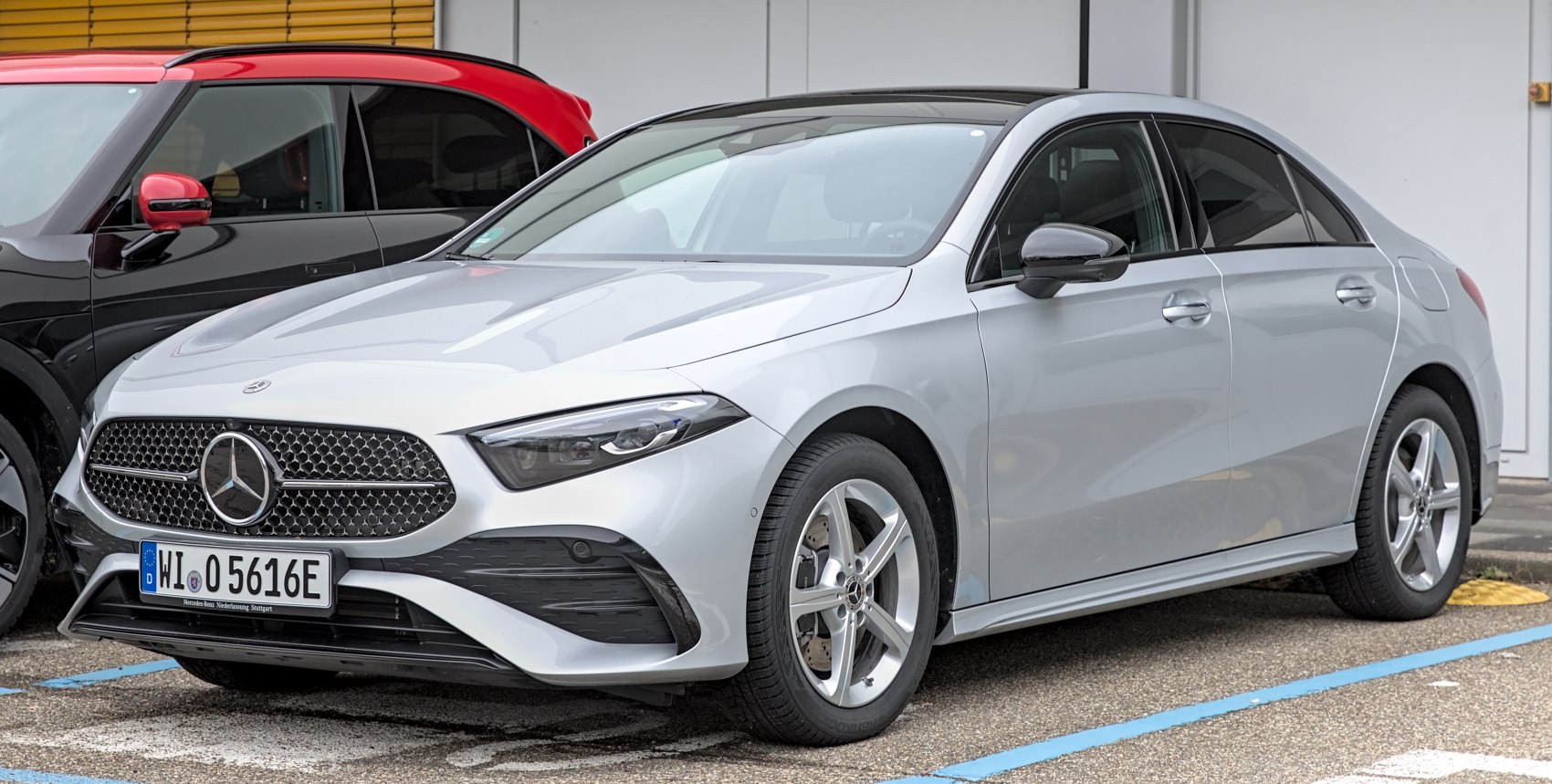 Front and side view of silver sedan with distinctive grille and alloy wheels