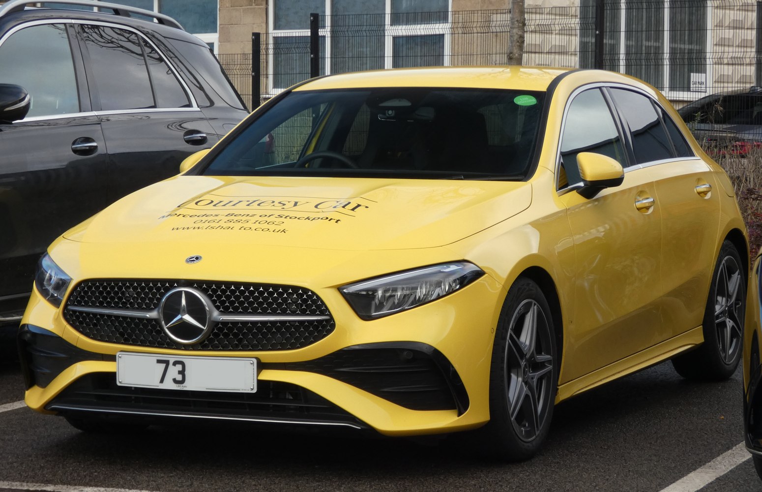 Yellow hatchback front with distinctive grille and sleek headlights