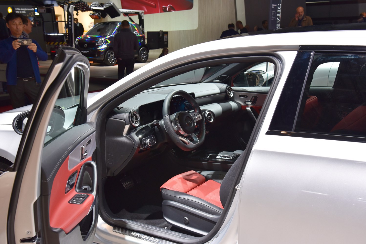 Interior with red and black seats, modern dashboard, and steering wheel